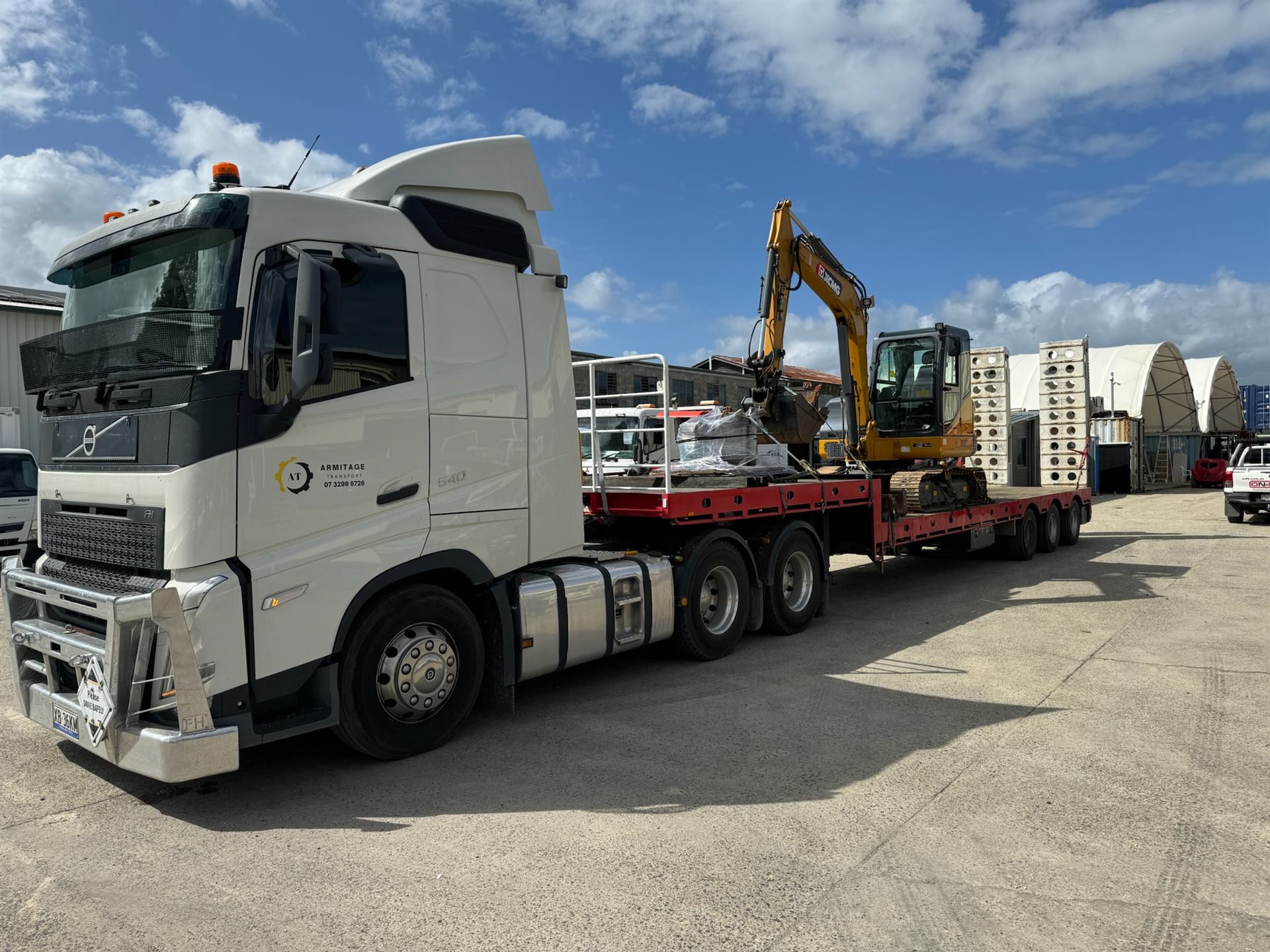 Armitage Transport low loader carrying an excavator and construction materials